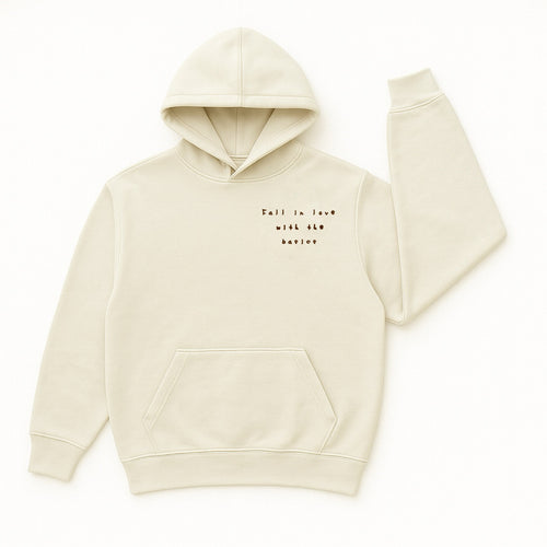 A cozy, cream hoodie with a affirmation puff print message: “fall in love with the basics.” Soft fabric hoodie is made for women.