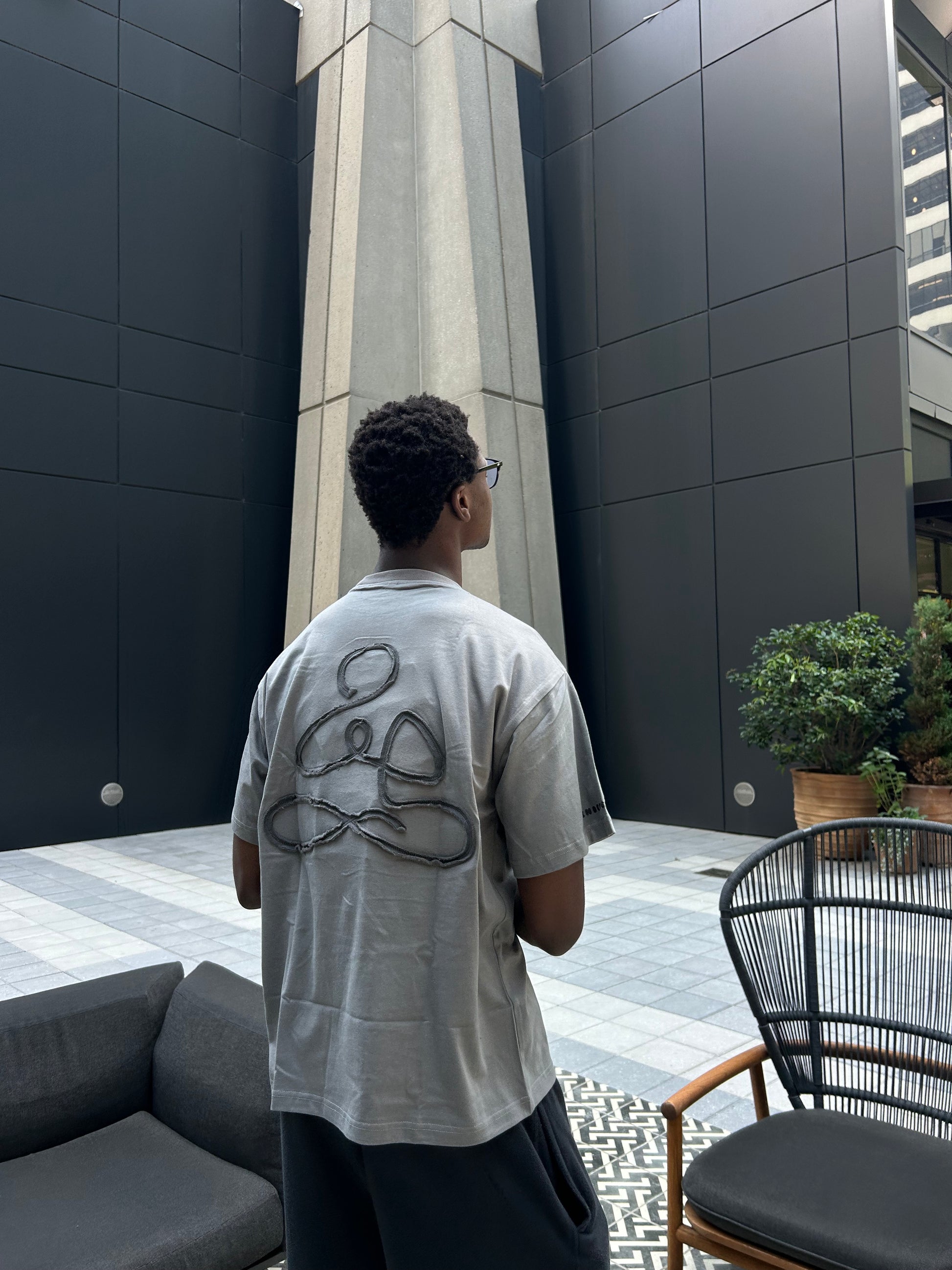Back view of dark grey ENDEN BRAND t-shirt with affirmations