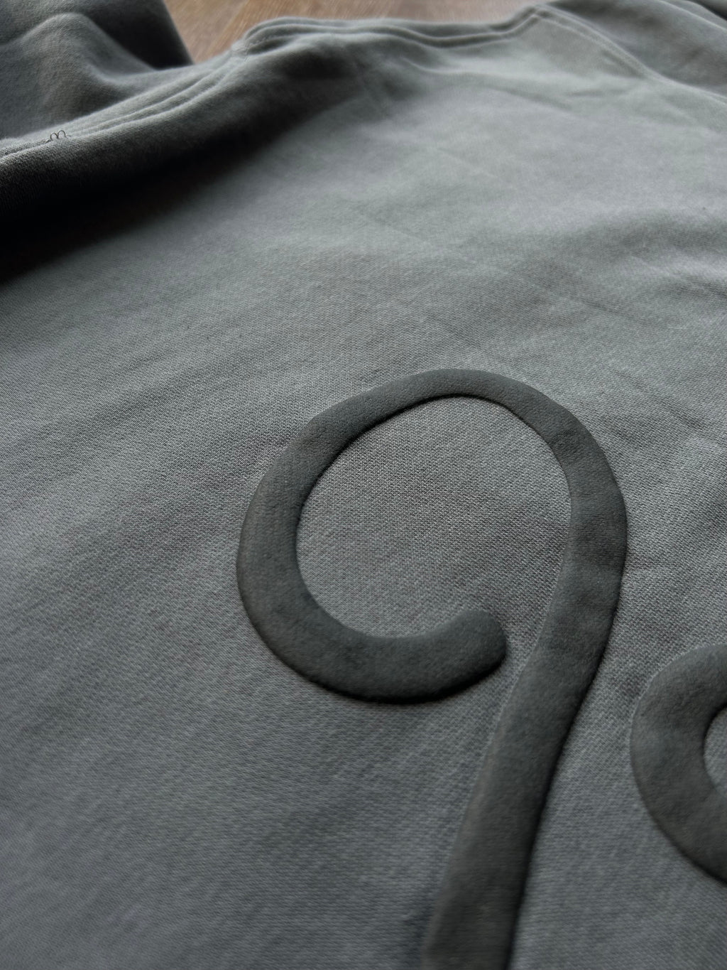 Close-up of hoodie puff print texture and stitching detail from ENDEN BRAND