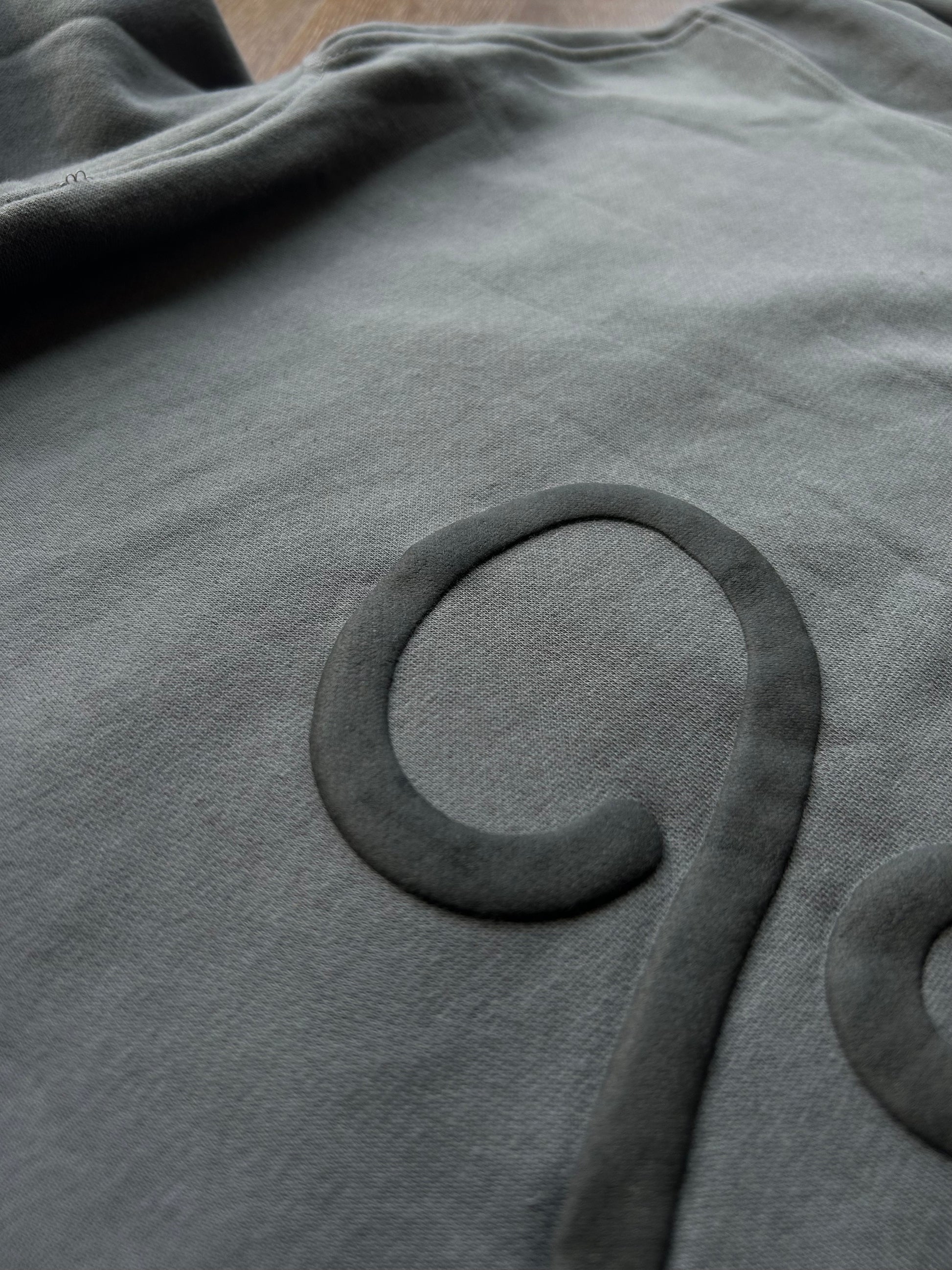 Close-up of hoodie puff print texture and stitching detail from ENDEN BRAND
