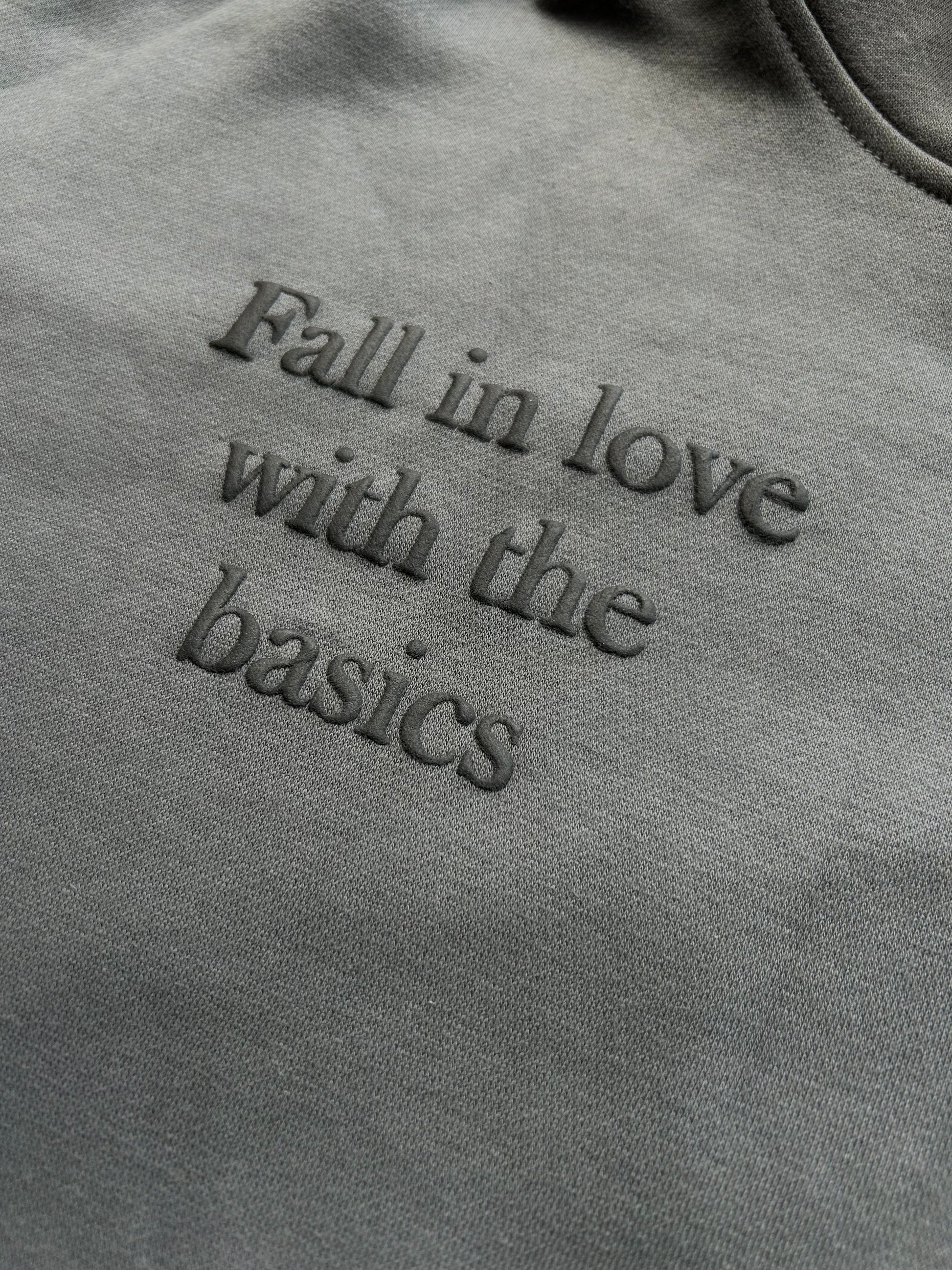 Close-up of puff print text “fall in love with the basics” on ENDEN BRAND hoodie